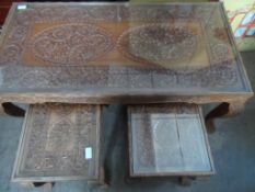 Nest of three hand carved teak coffee tables, with intricate floral carving and bamboo edging. 46