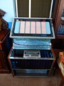 A Rockola Juke Box incl. a collection of 45 r.p.m. vintage records, the juke box being circa 1969,