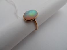 Lady`s gold ring, with an oval opal, Size M.