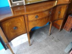 A Reproduction Mahogany Sideboard; the sideboard being serpentine fronted with two drawers to centre