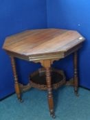 An Edwardian Mahogany Occasional Table, the table being octagonal and having a galleried shelf below