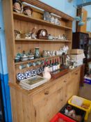 A large antique Welsh pine dresser having a shaped cornice to the top with open shelves, the base