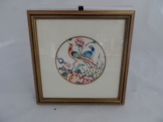 An antique oriental picture depicting two exotic birds, the picture being hand painted and circular,