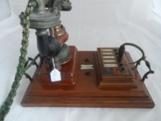 A vintage mahogany cradle phone, the phone with integral bell labelled J.McLellan Electrical