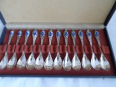 A Set of Twelve Continental Silver Spoons, the 833 hallmarked spoons having delft style porcelain