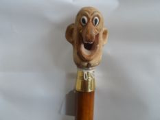 A Walking Cane topped with a comical bald gent`s head