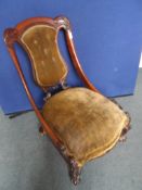 Victorian mahogany salon chair, the button back chair with moulded and carved frame, flanked by