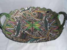 An ornate double handled bowl, painted by Jabu Ardmore studio 94 depicting salamanders and exotic