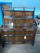 An Old Charm Style Oak Cottage Dresser having a plate rack and three cupboards to the top and