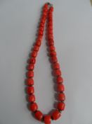Coral Necklace, the necklace having a silver S shaped clasp.