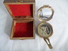 A reproduction brass compass in a wooden presentation box, Natural Sine Stanley London to the back.