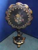 A Victorian papier mache tilt top occasional table having floral mother of pearl inlay