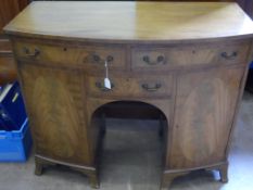 A Georgian style bow fronted kneehole desk having three drawers and two cupboards, approx. 107 x