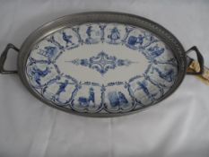 A Kurtz Evelpin Dutch Pewter and Delft Ware Tray, the Delft oval tile depicting scenes of day to day