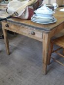 An antique pine farmhouse table having drawers to both ends, approx. 150 x 95 x 70 cms. together