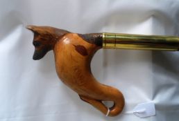 A Walking Stick having a fox`s body with glass eyes