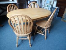An oval pine kitchen table supported on a bulbous centre column and four splayed feet, approx. 137 x