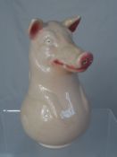 A Vintage Pottery Jug, the jug being in the form of a pig and having impressed marks to the base "