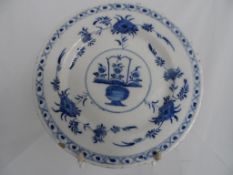 An 18th Century Delft blue and white plate, with cross border decoration and floral design 26 d.