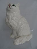 A Beswick figure of a white cat, #1867 to base, approx. 21 cms. and a porcelain figure of a boxer (