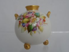 A miniature Royal Worcester vase, the vase having a hand painted wild flower frieze on ball feet