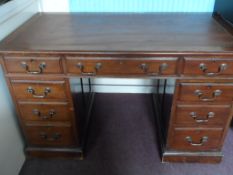 A mahogany twin pedestal desk having a leather top, central drawer and four graduated drawers to