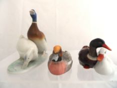 A Herend group of a pair of Ducks, one decorated in polychrome, the other white, approx. 7 cms