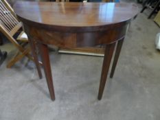 An antique mahogany demi lune open leaf occasional table on tapered legs, approx. 85 x 84 x 76 cms.