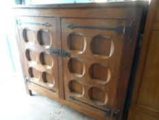 An antique Dutch heavy oak cabinet, the two doors being fashioned from two older doors, the