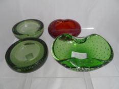 Four vintage Whitefriars bubble moulded bowls, three green and one ruby together with one other. (
