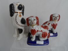 Black and White Staffordshire style spaniel together with two miniature red Staffordshire style