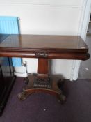 A Victorian mahogany swing top table, the table having carved foliate design to front, sides and