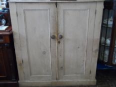 An antique pine kitchen cupboard having three shelves to the interior and being on a plinth base,