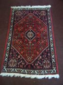 A Middle Eastern style hall rug, approx. 103 x 67 cms.