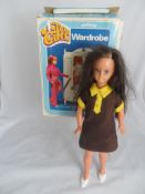 A vintage boxed action girl with wardrobe and clothes and another articulated plastic doll