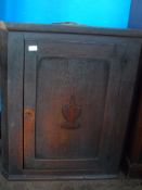 An Antique Oak Corner Cupboard having a panelled door with decoration to the centre, approx. 72 x 39