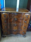 Queen Anne style walnut serpentine fronted chest of drawers on ball feet with four graduated