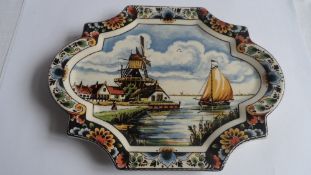 A MID 20th CENTURY DUTCH DELFT QUATREFOIL PLAQUE DEPICTING A TYPICAL SCENE OF A WINDMILL AND BARGES,