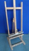 A LARGE WOODEN " ROWNEY " ARTIST`S EASEL, APPROX. 200 cms HIGH AND 58 cms WIDE