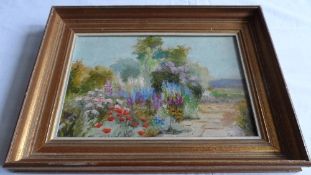 AN ORIGINAL FRAMED OIL ON BOARD DEPICTING A COTTAGE GARDEN, SIGNED EVA WALBOURN TO THE REVERSE,