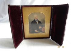 AN ANTIQUE LEATHER CASE DAGLIOTYPE CONTAINING A WATERCOLOUR OF AN EDWARDIAN GENTLEMAN HOLDING A