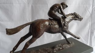 A BRONZE EFFECT FIGURE OF STAN MELLOR WINNING HIS 1000TH RACE ON OUZO, NOTTINGHAM 1971