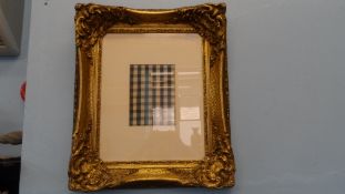 AN ORNATE GILT WOOD FRAME HAVING A CENTRAL GINGHAM PANEL, APPROX. 60 X 70 cms INCLUDING THE FRAME