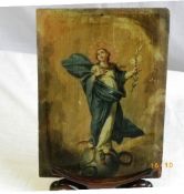 A 19th CENTURY WOODEN PANEL DEPICTING A SAINT UPON A GLOBE WITH LILY AND APPLE IN HAND. APPROX. 19 X