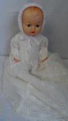 A VINTAGE CELLULOID DOLL WITH HAND MADE CLOTHES.