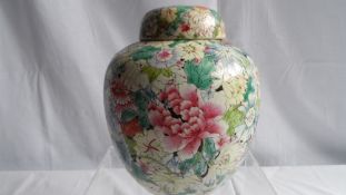 A CIRCA 1900 FAMILLE ROSE GINGER JAR DEPICTING FLOWERS, PEONY TO THE LID - FISH MARK TO BASE