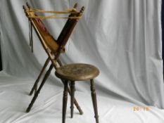 AN ANTIQUE MINIATURE CARVED OAK STOOL TOGETHER WITH A TRAVELLING SEWING BAG ON A STAND (2)