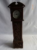 A MINIATURE WOODEN GRANDFATHER CLOCK WITH VINTAGE ALARM CLOCK TO TOP 38 cms