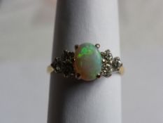 A LADY`S 18ct YELLOW AND WHITE GOLD DIAMOND AND OPAL RING. 6 X 4.5 PTS. DIAMONDS - 27 PTS. TOTAL.