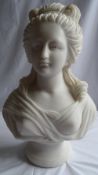 A CARVED WHITE MARBLE BUST OF A WOMAN, ON A TURNED SCOTIA, 56 x 38 cms